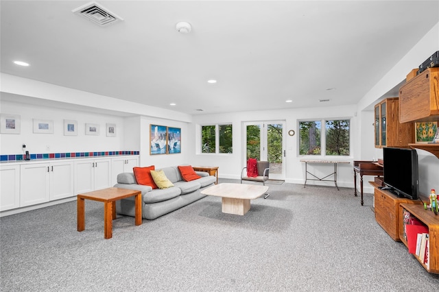 living room featuring carpet, recessed lighting, and visible vents