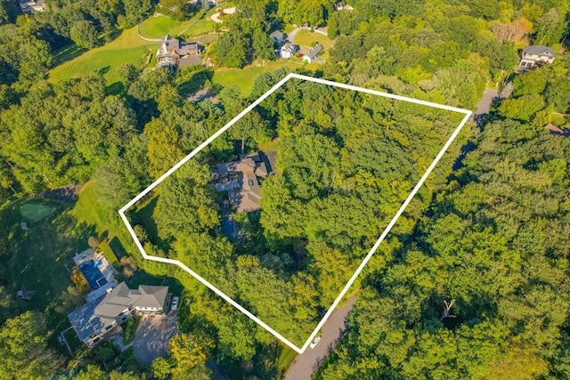 birds eye view of property featuring a wooded view