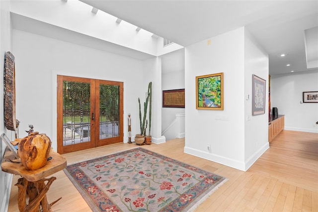 foyer featuring french doors, recessed lighting, light wood finished floors, and baseboards