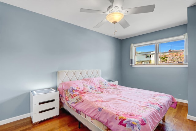 bedroom with baseboards, a ceiling fan, and wood finished floors
