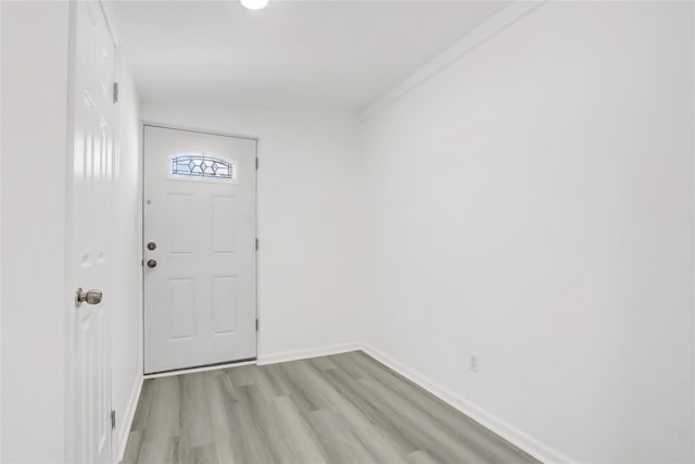 entryway with baseboards and light wood finished floors