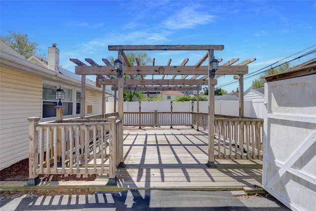 deck with a pergola and fence