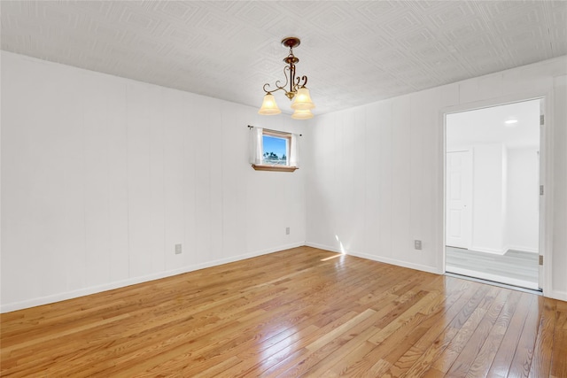 14-46 142nd St, Whitestone, NY 11357 - spare room featuring light wood-type flooring, baseboards, and a chandelier