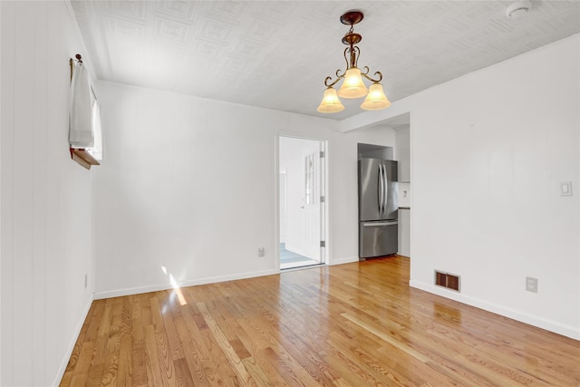 14-46 142nd St, Whitestone, NY 11357 - spare room featuring light wood-style flooring, baseboards, and a chandelier