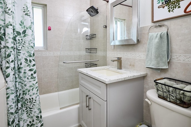full bath with shower / bath combo with shower curtain, vanity, toilet, and tile walls
