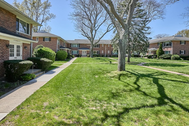 view of community featuring a residential view and a lawn