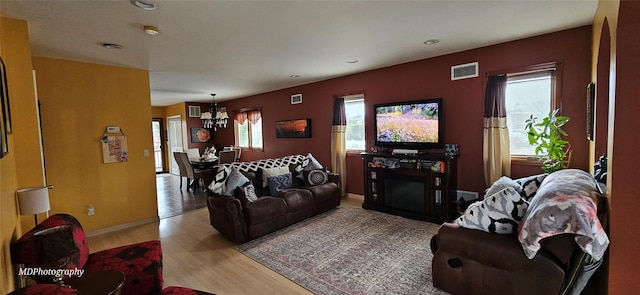 living area with visible vents, recessed lighting, light wood-style floors, and a chandelier