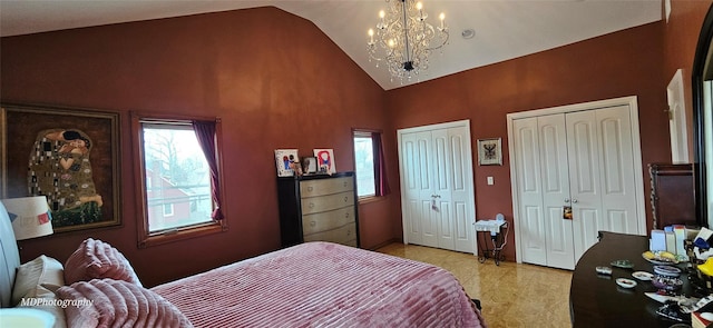 bedroom featuring high vaulted ceiling, two closets, and a notable chandelier