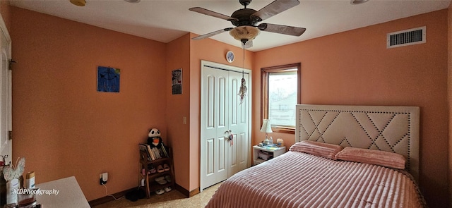carpeted bedroom with baseboards, a ceiling fan, a closet, and visible vents