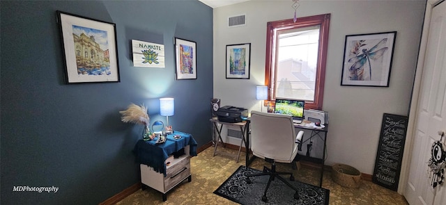 office space featuring baseboards and visible vents