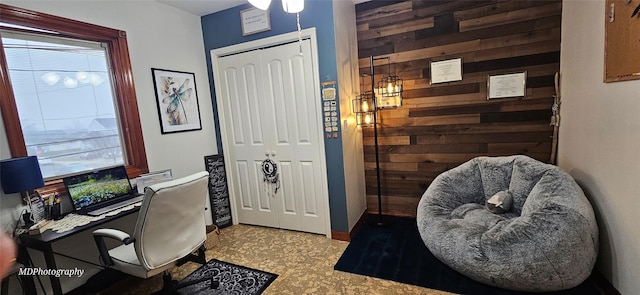 office area with wood walls