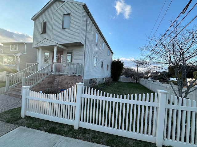 view of front of house with crawl space and a fenced front yard