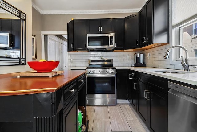 44 Parkway Rd, Bronxville, NY 10708 - kitchen with dark cabinets, appliances with stainless steel finishes, decorative backsplash, and a sink