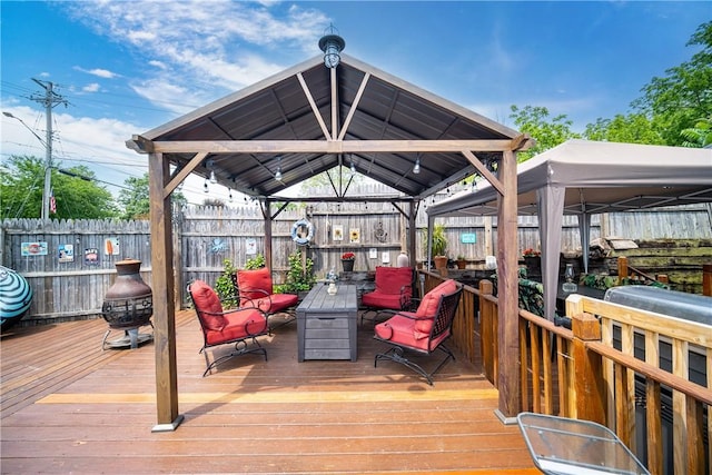 wooden deck with a gazebo and fence