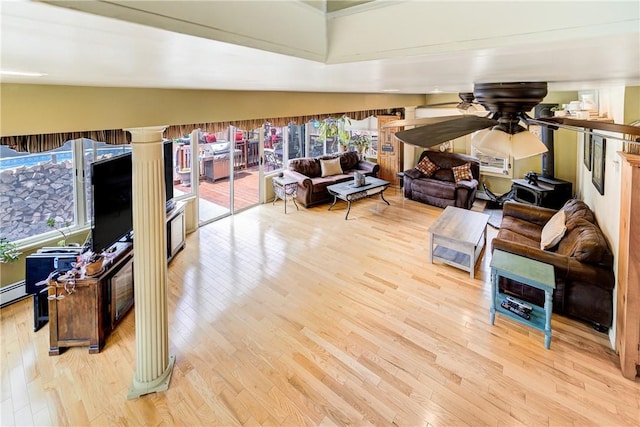living room with baseboard heating, a ceiling fan, wood finished floors, and lofted ceiling