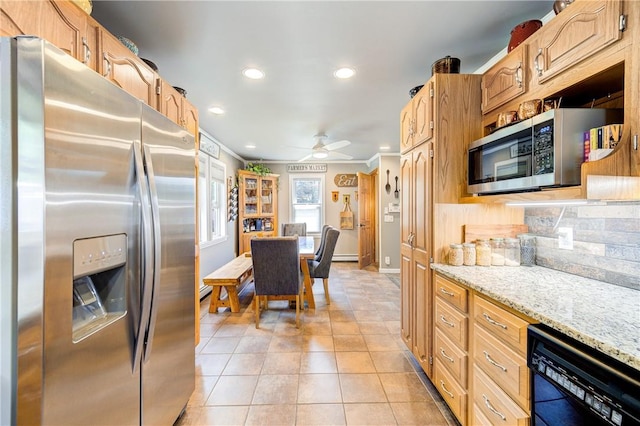 kitchen featuring crown molding, appliances with stainless steel finishes, light tile patterned floors, baseboards, and recessed lighting