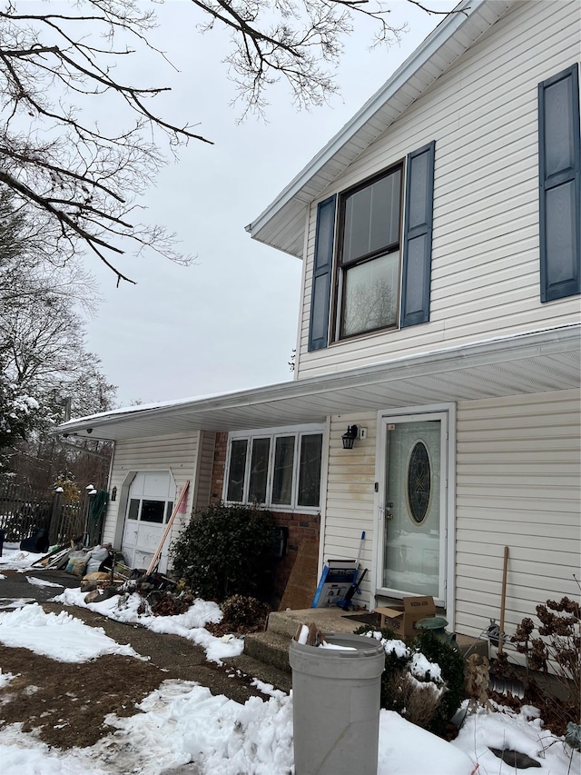 view of front of house featuring an attached garage and entry steps