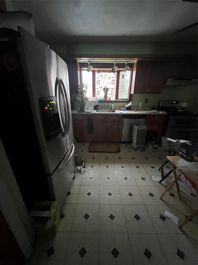 kitchen with a sink, stove, stainless steel refrigerator with ice dispenser, and extractor fan