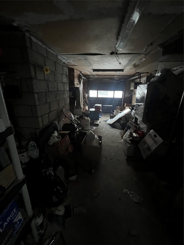 interior space with a garage and concrete block wall
