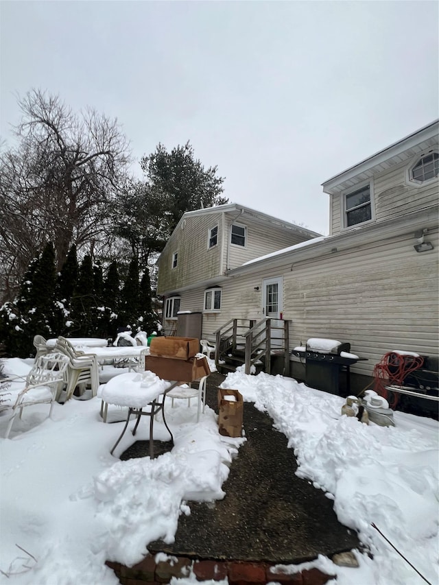 snow covered house with a deck