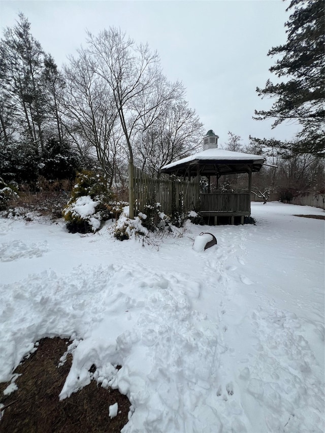 yard covered in snow featuring a gazebo