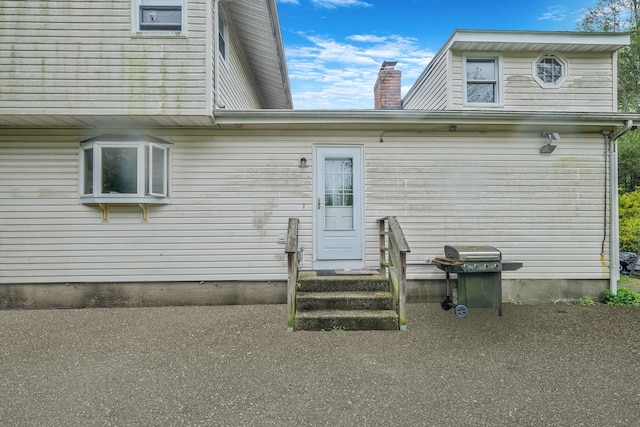 25 Adrienne Ln, Hauppauge, NY 11788 - back of house featuring a chimney