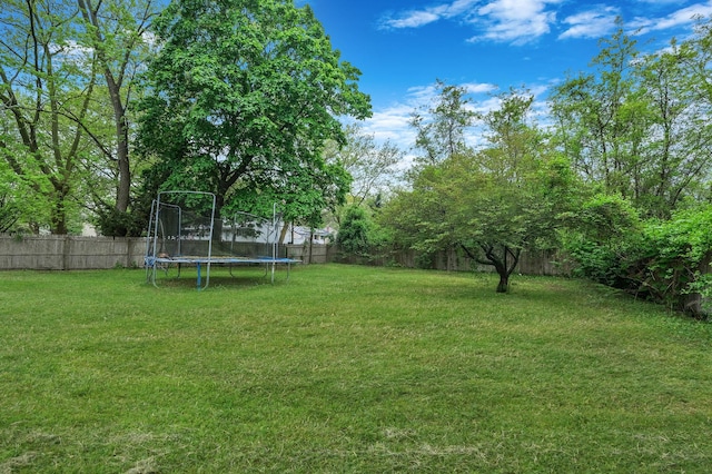25 Adrienne Ln, Hauppauge, NY 11788 - view of yard with a trampoline and a fenced backyard