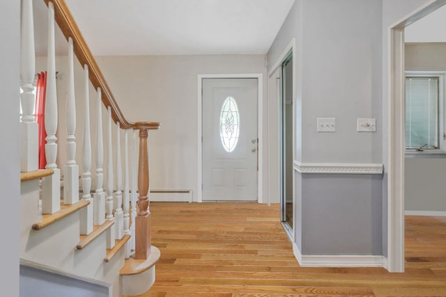 25 Adrienne Ln, Hauppauge, NY 11788 - foyer featuring stairway, a baseboard radiator, light wood-style flooring, and baseboards