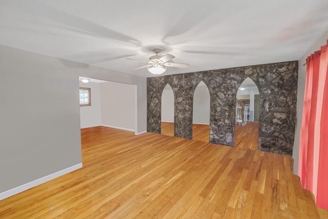 25 Adrienne Ln, Hauppauge, NY 11788 - spare room with arched walkways, baseboards, wood-type flooring, and ceiling fan