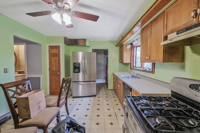 25 Adrienne Ln, Hauppauge, NY 11788 - kitchen with a sink, brown cabinetry, stainless steel appliances, light floors, and under cabinet range hood