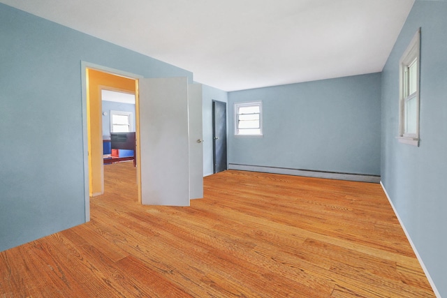 25 Adrienne Ln, Hauppauge, NY 11788 - unfurnished room featuring wood finished floors and baseboard heating