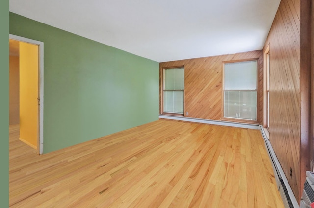25 Adrienne Ln, Hauppauge, NY 11788 - spare room featuring wooden walls, wood finished floors, and a baseboard radiator