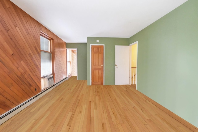 25 Adrienne Ln, Hauppauge, NY 11788 - interior space featuring wooden walls, a baseboard heating unit, and wood-type flooring