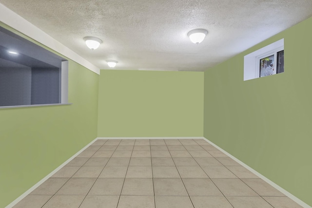 25 Adrienne Ln, Hauppauge, NY 11788 - finished basement with a textured ceiling, baseboards, and light tile patterned floors