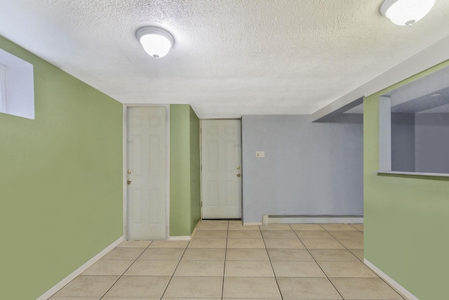 25 Adrienne Ln, Hauppauge, NY 11788 - empty room with light tile patterned floors, a textured ceiling, baseboards, and baseboard heating