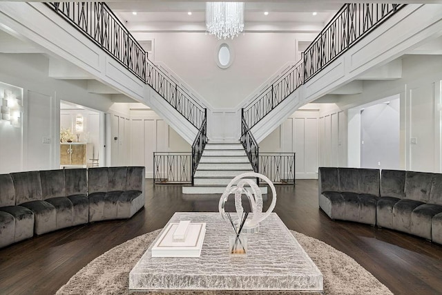 living area featuring an inviting chandelier, stairs, wood finished floors, a high ceiling, and recessed lighting