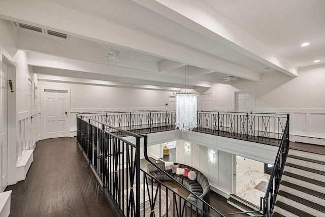 hall with beamed ceiling, an upstairs landing, and visible vents