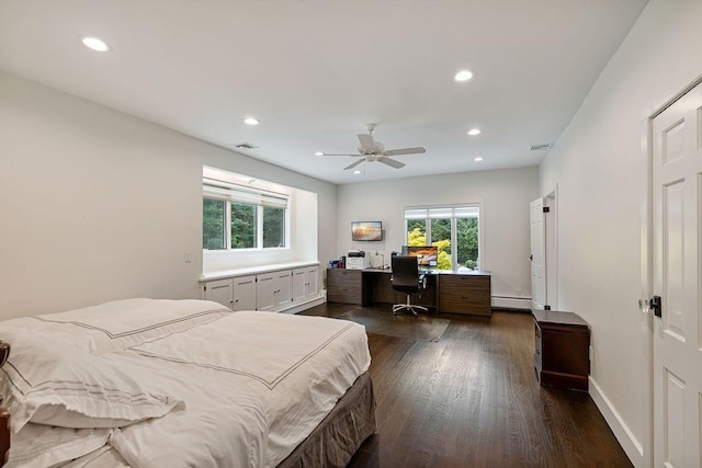 bedroom featuring a baseboard radiator, multiple windows, recessed lighting, and dark wood-type flooring