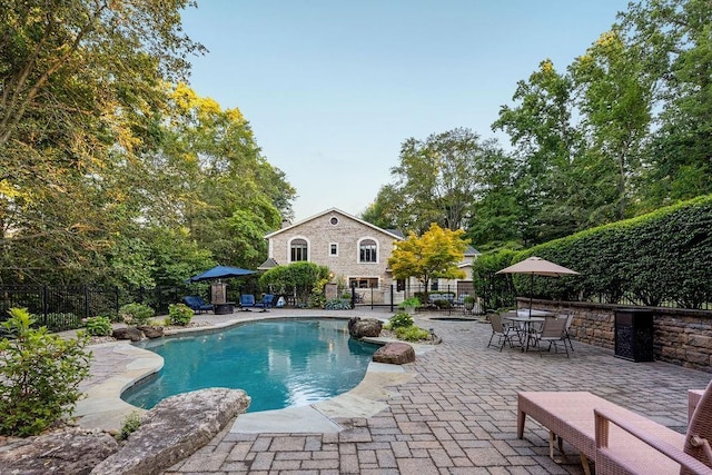 view of pool with a patio, fence, and a fenced in pool