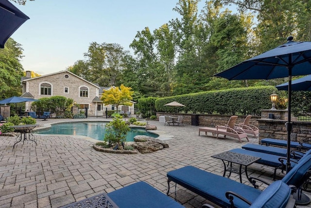 view of pool featuring a patio, fence, and a fenced in pool