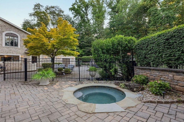 view of swimming pool with an in ground hot tub and fence
