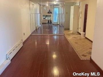 25-54 12th St Unit 3D, Long Island City, NY 11102 - hallway featuring a baseboard heating unit and wood finished floors