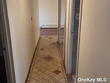 25-54 12th St Unit 3D, Long Island City, NY 11102 - hall featuring tile patterned flooring and a baseboard radiator