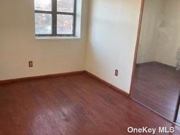 25-54 12th St Unit 3D, Long Island City, NY 11102 - unfurnished bedroom with baseboards and wood finished floors