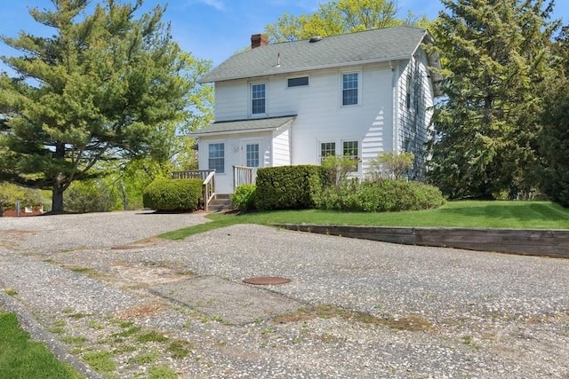 645 Hamilton Ave, Mattituck, NY 11952 - back of house with a chimney, a wooden deck, and a yard