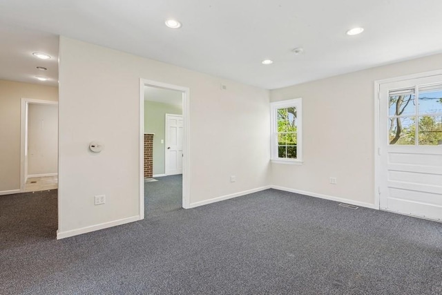 645 Hamilton Ave, Mattituck, NY 11952 - unfurnished room featuring dark carpet, plenty of natural light, baseboards, and recessed lighting