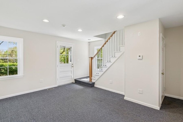 645 Hamilton Ave, Mattituck, NY 11952 - foyer with plenty of natural light, stairs, dark colored carpet, and recessed lighting