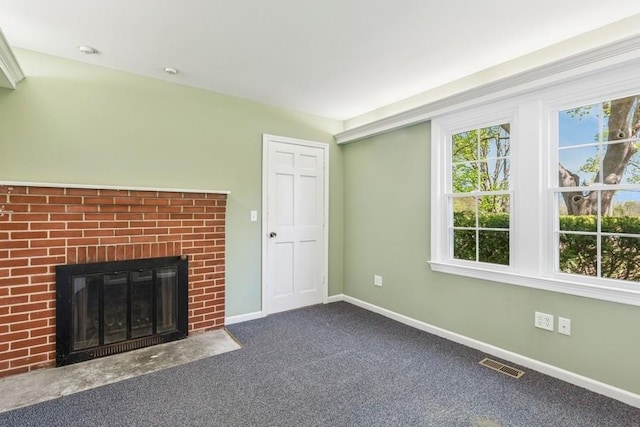 645 Hamilton Ave, Mattituck, NY 11952 - unfurnished living room with baseboards, a brick fireplace, and carpet floors