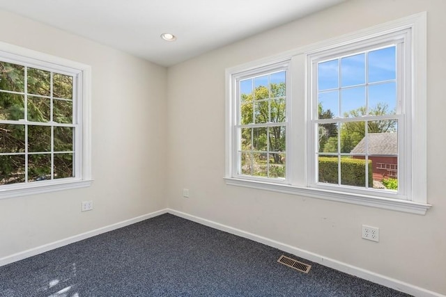 645 Hamilton Ave, Mattituck, NY 11952 - spare room featuring healthy amount of natural light, baseboards, dark colored carpet, and recessed lighting