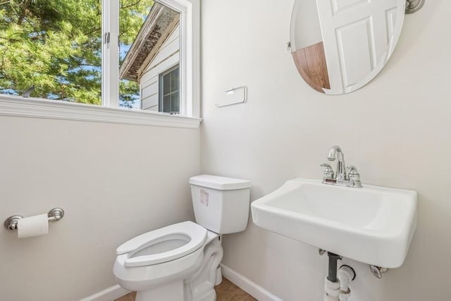 645 Hamilton Ave, Mattituck, NY 11952 - half bathroom featuring toilet, baseboards, and a sink